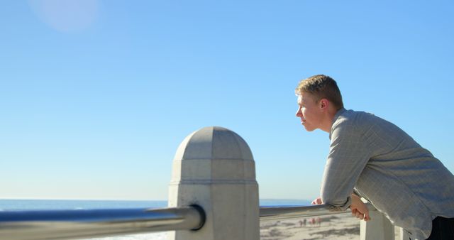 Man Contemplating by the Ocean on a Sunny Day - Download Free Stock Images Pikwizard.com
