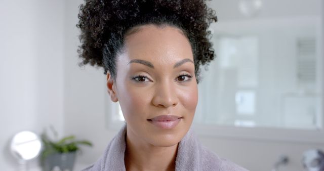 Confident Woman With Curly Hair Smiling in Modern Bathroom - Download Free Stock Images Pikwizard.com