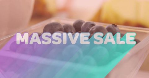 Displaying blueberries in clear clamshell with massive sale gradient overlay