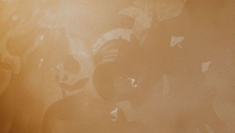 Beige translucent panel revealing smudges and residue marks minimalist texture