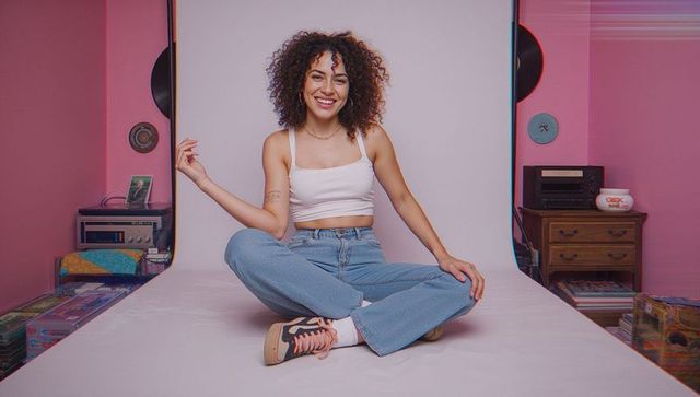 Happy Young Woman in Casual Fashion in Retro-Style Studio