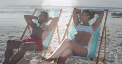 Relaxed Couple Sunbathing on Serene Beach - Download Free Stock Images Pikwizard.com