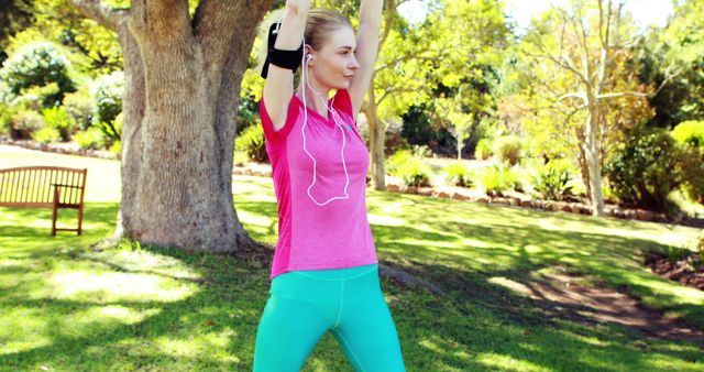 Woman Stretching Outdoors in Pink Shirt and Teal Leggings - Download Free Stock Images Pikwizard.com