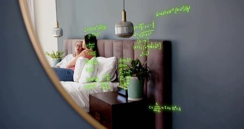 Mother and daughter reclining on bed reflected in mirror, neon equations floating