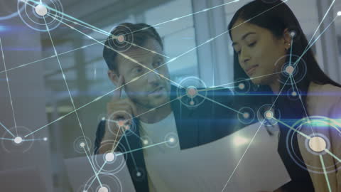 Business Professionals Analyzing Data With Digital Network Overlay