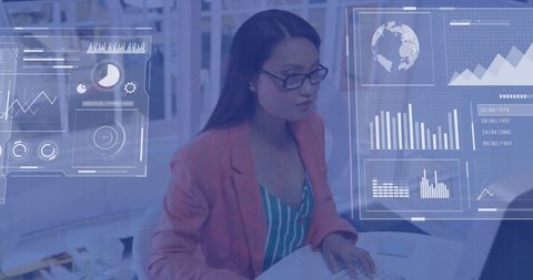 Asian businesswoman analyzing financial data on computer in office