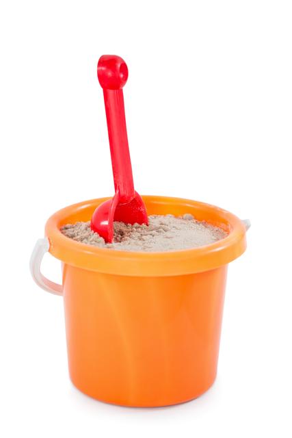 This image shows a close-up of an orange toy bucket filled with sand and a red spade, isolated on a white background. It is perfect for use in advertisements for children's toys, beach products, or summer activities. It can also be used in educational materials or parenting blogs discussing playtime and outdoor activities for children.