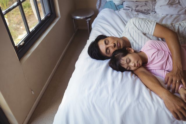 Father and daughter sleeping together in bedroom - Download Free Stock Photos Pikwizard.com