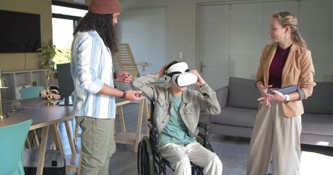 Demonstrating vr rehab for wheelchair user with diverse clinical team in modern therapy room