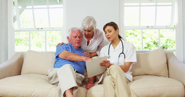 Senior Couple Consulting with Healthcare Professional at Home - Download Free Stock Images Pikwizard.com