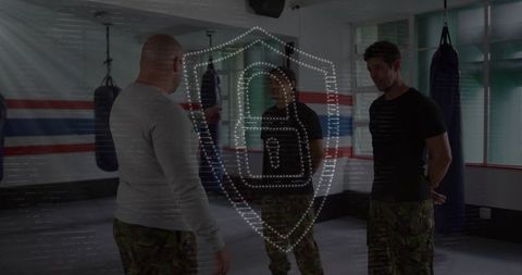 Instructor training partners in boxing gym for combat fitness