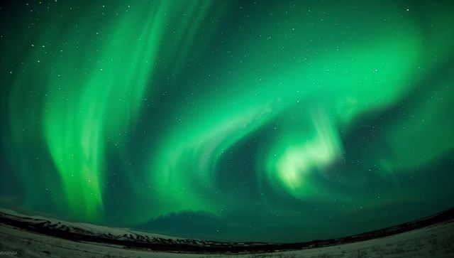 Dancing green aurora borealis swirling over snowy plain and distant mountain ridge under starry sky