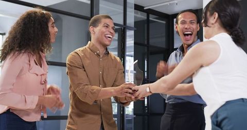 Diverse Coworkers Celebrating Award in Modern Office