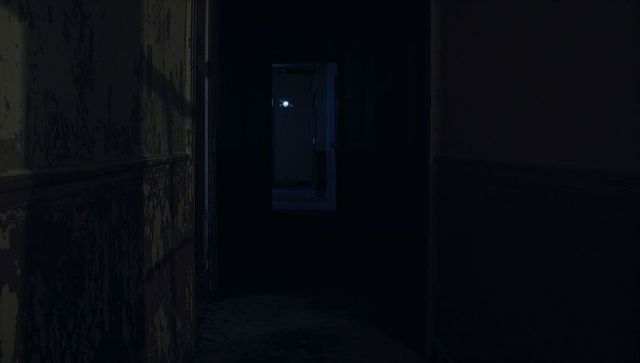 Blue light seeping through doorway at end of peeling paint corridor