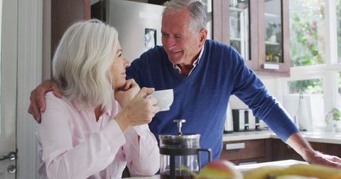 Happy Senior Couple Enjoying Coffee Together in Bright Kitchen