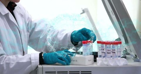 Laboratory technician handling red-capped sample vials and operating benchtop analyzer