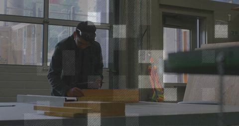 Carpenter Measuring Wooden Plank in Workshop