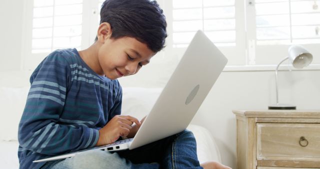 Young Boy Using Laptop on Bed - Download Free Stock Images Pikwizard.com