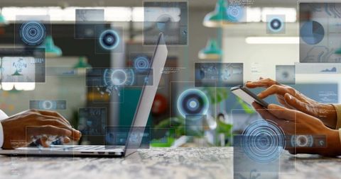 Business team collaborating with laptop and smartphone showing ar dashboards and analytics