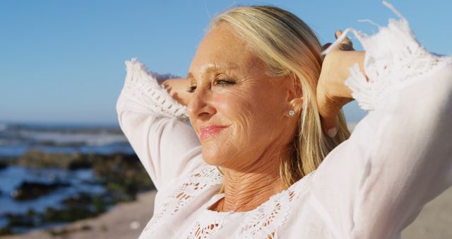 Happy Senior Woman Relaxing on Beach at Sunset - Download Free Stock Images Pikwizard.com