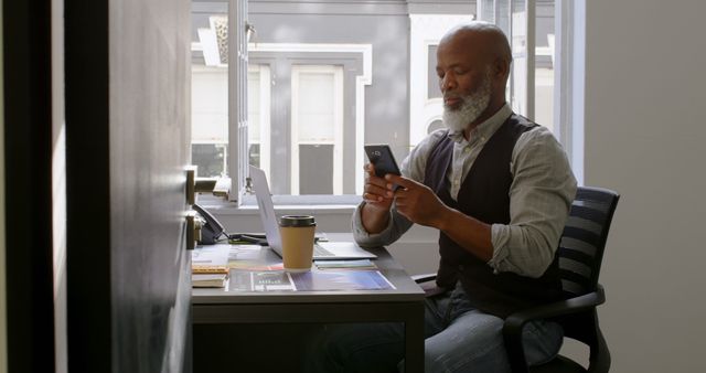 Mature African American Man Working on Smartphone at Desk - Download Free Stock Images Pikwizard.com