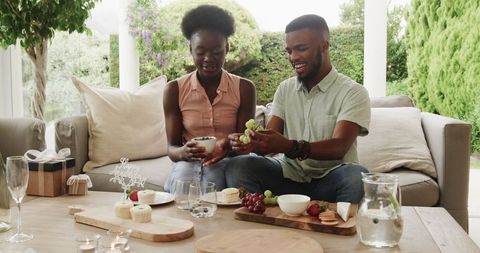 Young Couple at Outdoor Table Enjoying Romantic Snack Time