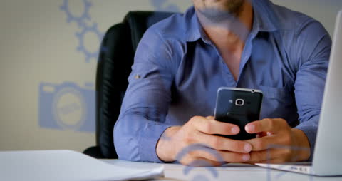 Businessman Using Smartphone with Digital Icons Overlay