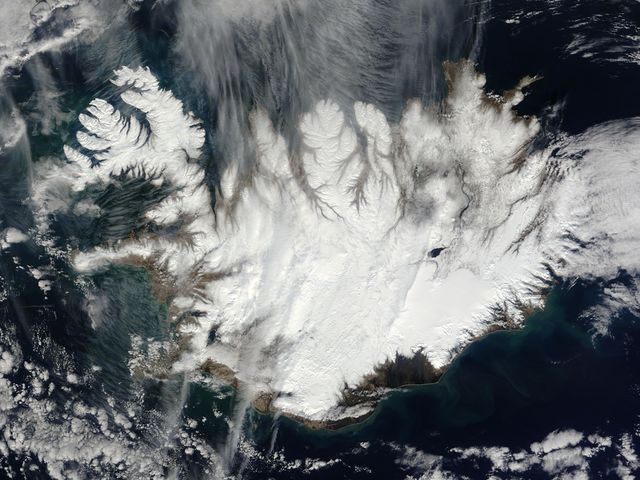 Capturing a nearly cloud-free view, this image shows Iceland's snow-covered landscape from space. Taken by the MODIS instrument on the Terra spacecraft on April 15, 2015, this stunning view is useful for education materials on geosciences, environmental studies, and space exploration topics. It can also be perfect for illustrating articles and presentations about Iceland, climate change, and satellite imagery.