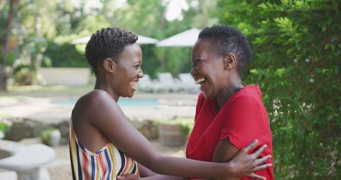 Joyful Mother and Daughter Embracing in Garden