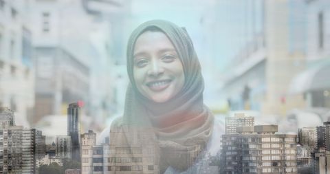 Smiling Asian Woman in Hijab Over Double Exposure Cityscape