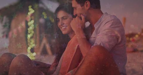 Romantic Couple Celebrating on Beach with Festive Overlay