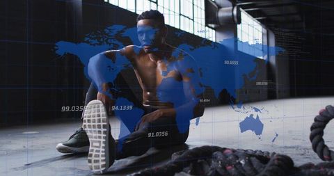Athlete resting on gym floor with battle ropes and global data hud overlay