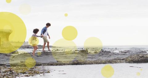Joyful Couple Walking Along Scenic Beach Rocks - Download Free Stock Images Pikwizard.com