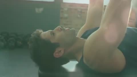 Man Performing Bench Press Under Backlight with Motion Lines and Cinematic Lens Flare