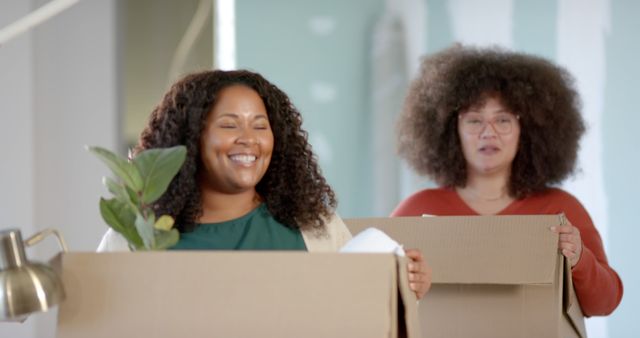Smiling Women Packing Moving Boxes in New House - Download Free Stock Images Pikwizard.com