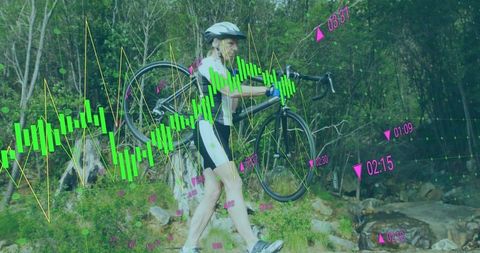 Woman carrying bicycle crossing trail with data overlay