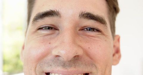 Man Smiling in Soft Natural Light Radiating Contentment and Wellness