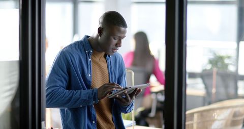African American Businessman Using Tablet in Modern Office - Download Free Stock Images Pikwizard.com