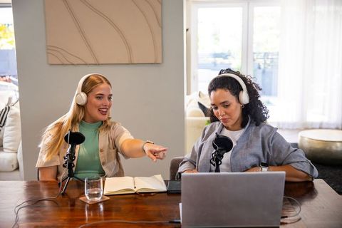 Diverse female co-hosts recording podcast at home