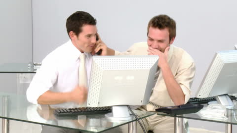 Cheerful Colleagues Enjoying Success and Teamwork in Busy Office