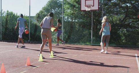Women Basketball Team Training Outdoors on Sunny Day