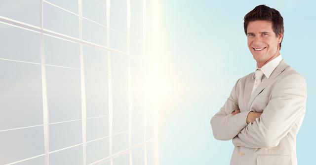 Businessman standing confidently with arms crossed in front of a translucent, modern background with sunlight, indicating professionalism and success. Suitable for corporate, leadership, and business success themes.
