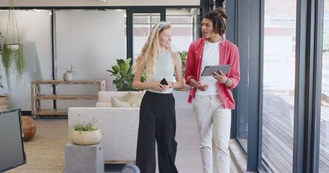 Two Colleagues Collaborating Enthusiastically in Modern Office