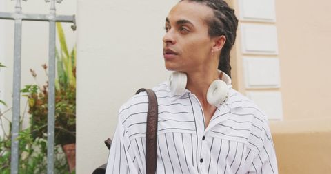 Young Professional with Headphones Ready for Urban Exploration