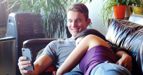 Happy Couple Relaxing Together on Comfortable Sofa