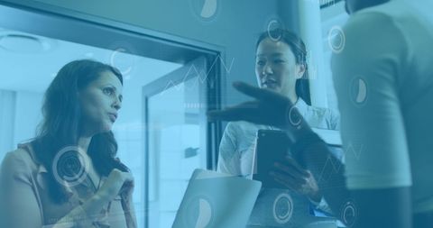 Diverse Professionals Discussing Data Analytics in Modern Office