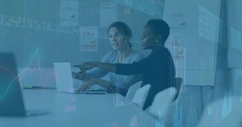 Businesswomen collaborating in modern conference room
