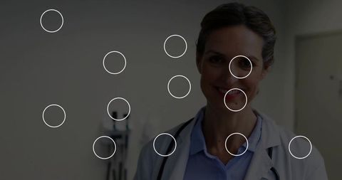 Doctor Holding Stethoscope in Clinic Corridor with Medical Instruments