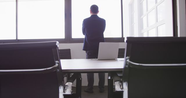 Businessman Contemplating at Office Window - Download Free Stock Images Pikwizard.com