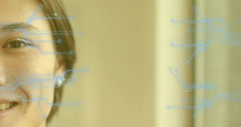 Asian man face overlaid with digital circuitry for cybersecurity concept